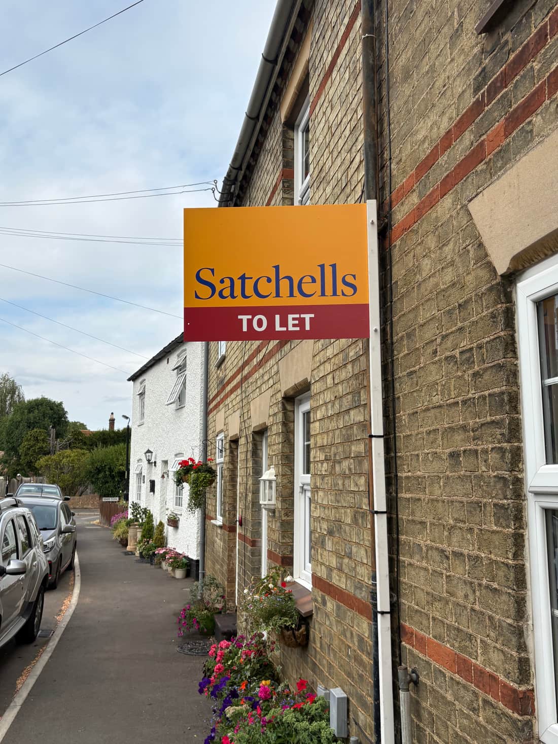 A Satchells To Let board outside a terraced cottage